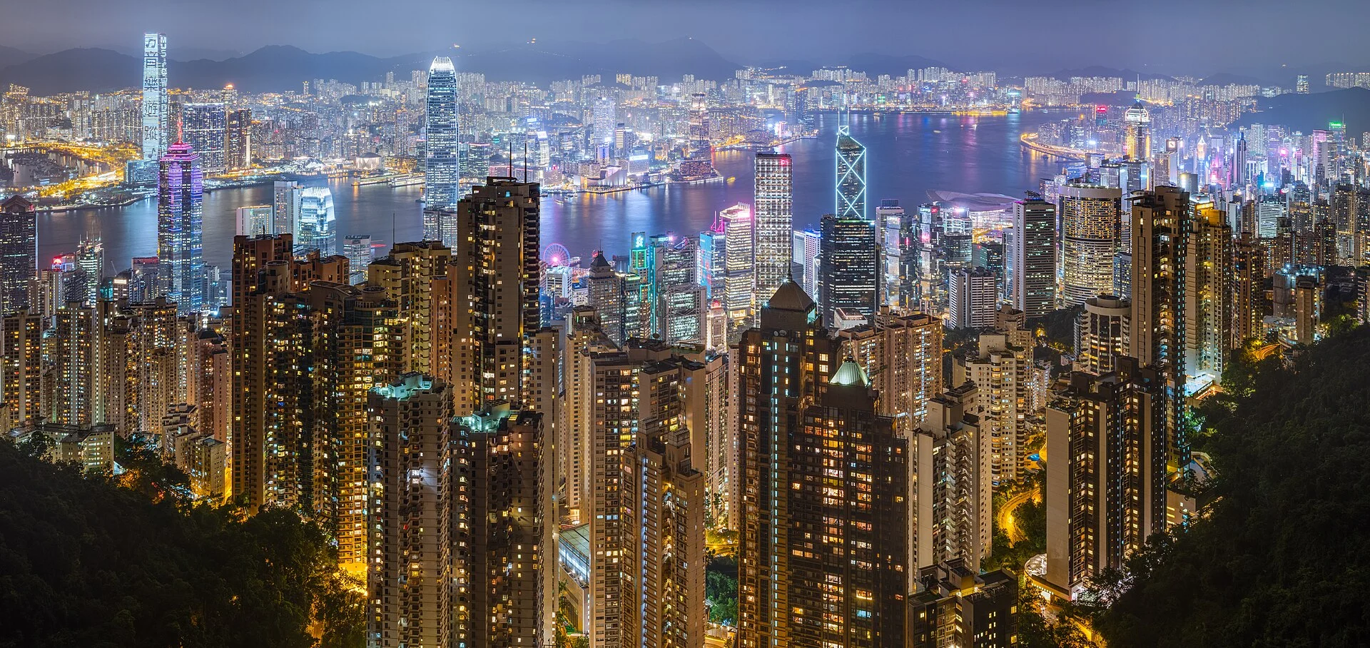 Hong Kong skyline illuminated across Victoria Harbour